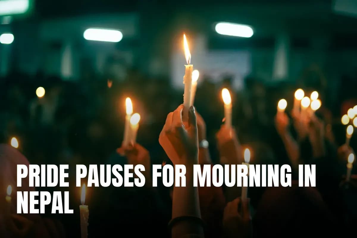 A crowd holds lit candles in a nighttime protest, symbolizing unity and hope.