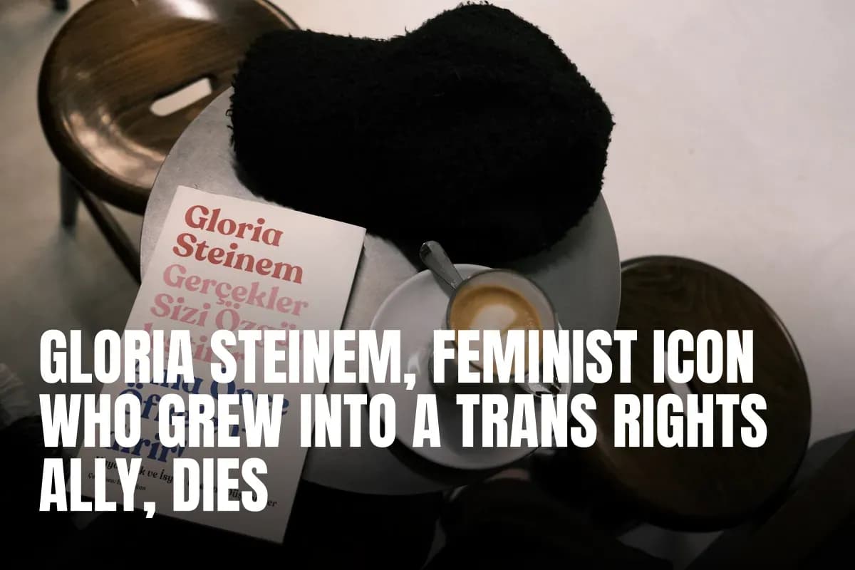 A café setting with a latte, book by Gloria Steinem, and cozy hat on a table.