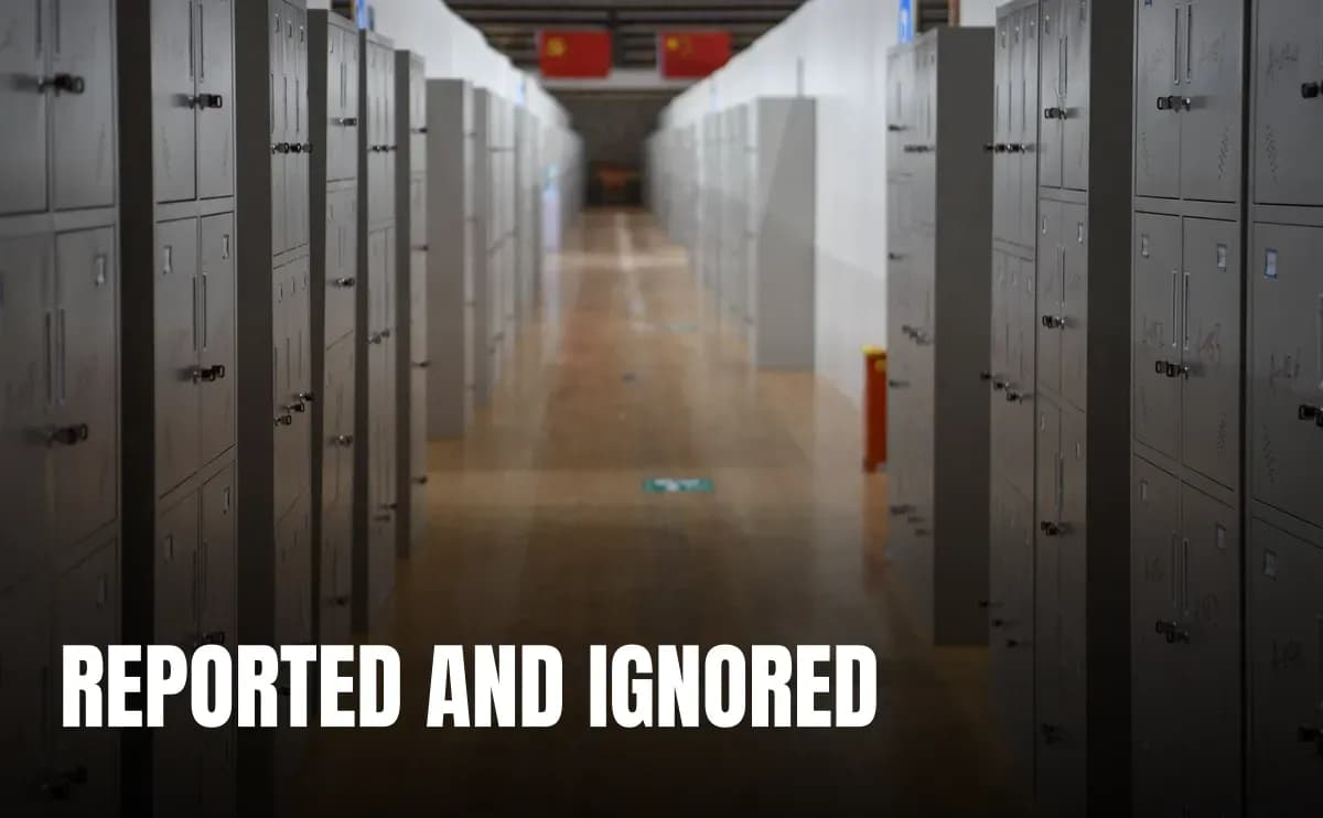 A perspective view of a long hallway featuring rows of metal lockers and wooden flooring.