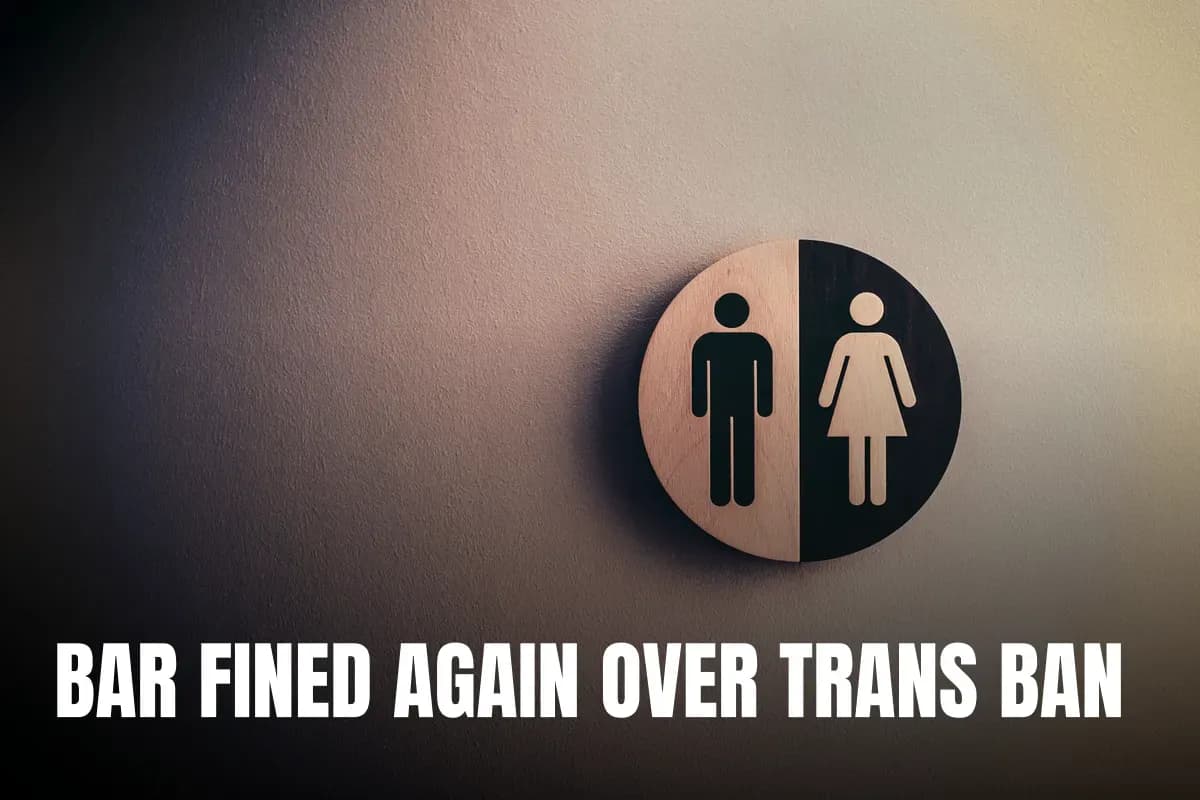 Minimalist gender neutral restroom sign with male and female symbols on textured wall.