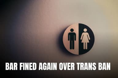 Minimalist gender neutral restroom sign with male and female symbols on textured wall.
