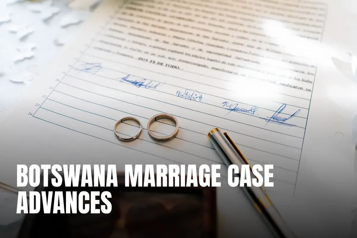 Elegant wedding rings laid on a signed marriage certificate, symbolizing commitment.