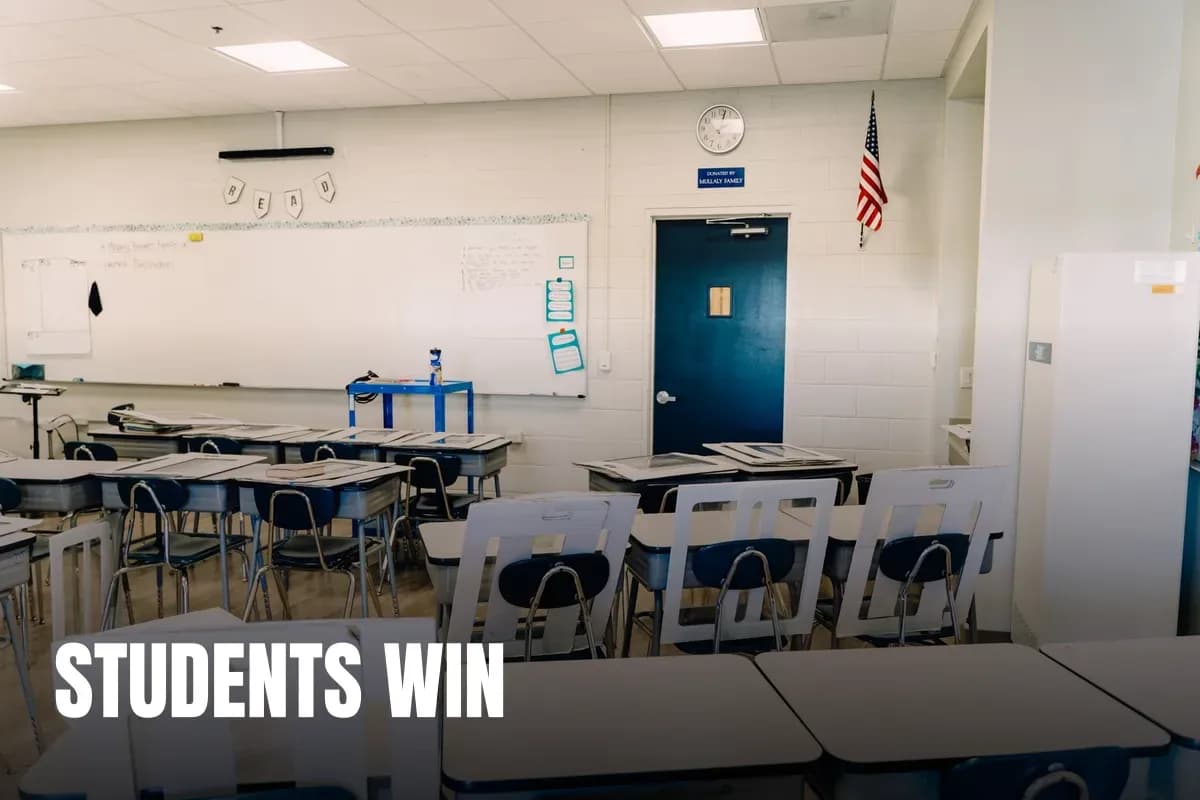 Bright empty classroom featuring desks, a whiteboard, and an American flag. Ideal learning environment.