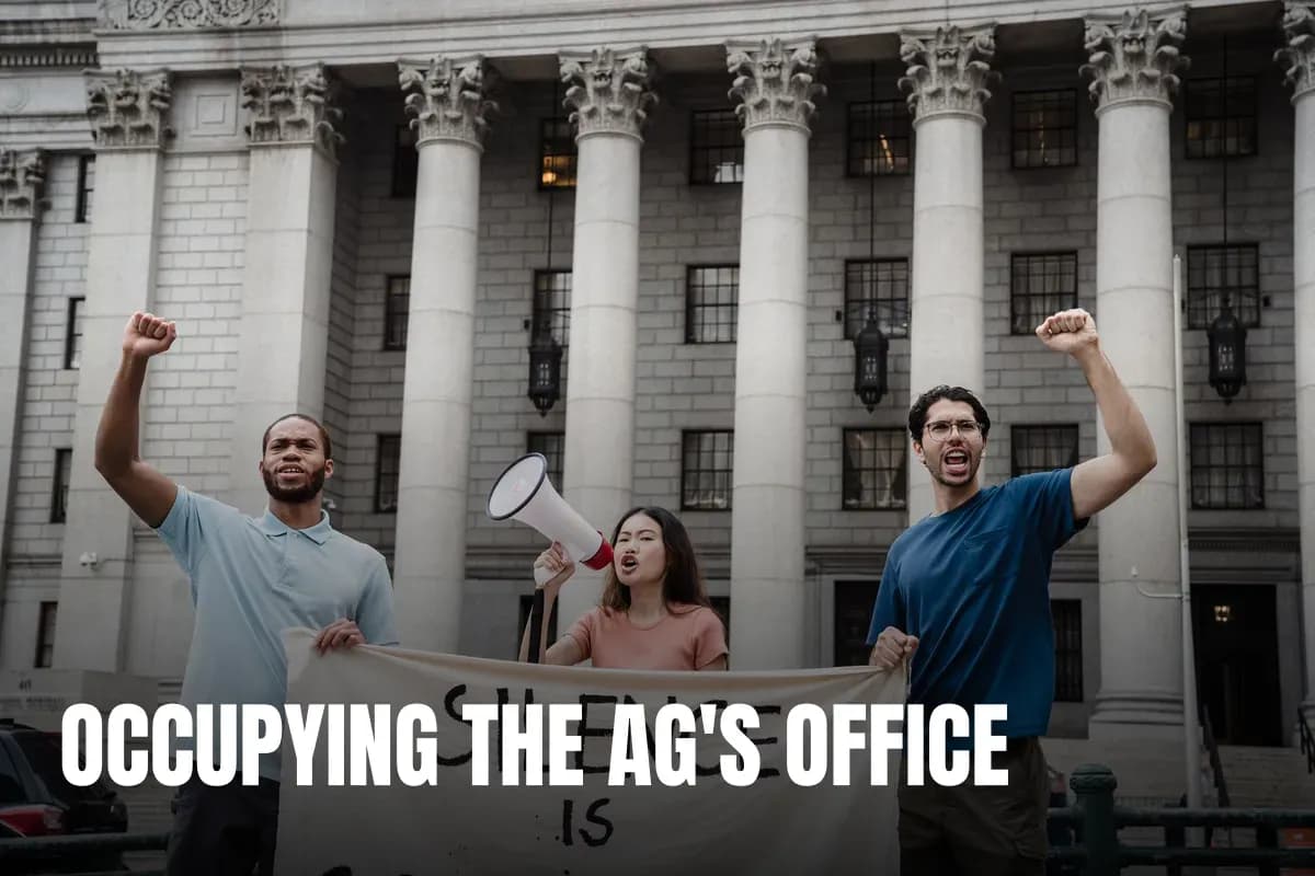 Group of activists raising fists and chanting with a protest banner outside a government building.